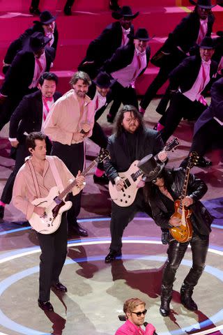 <p>Kevin Winter/Getty</p> Mark Ronson, Ryan Gosling, and Slash perform 'I'm Just Ken' from "Barbie" onstage during the 96th Annual Academy Awards at Dolby Theatre on March 10, 2024 in Hollywood, California