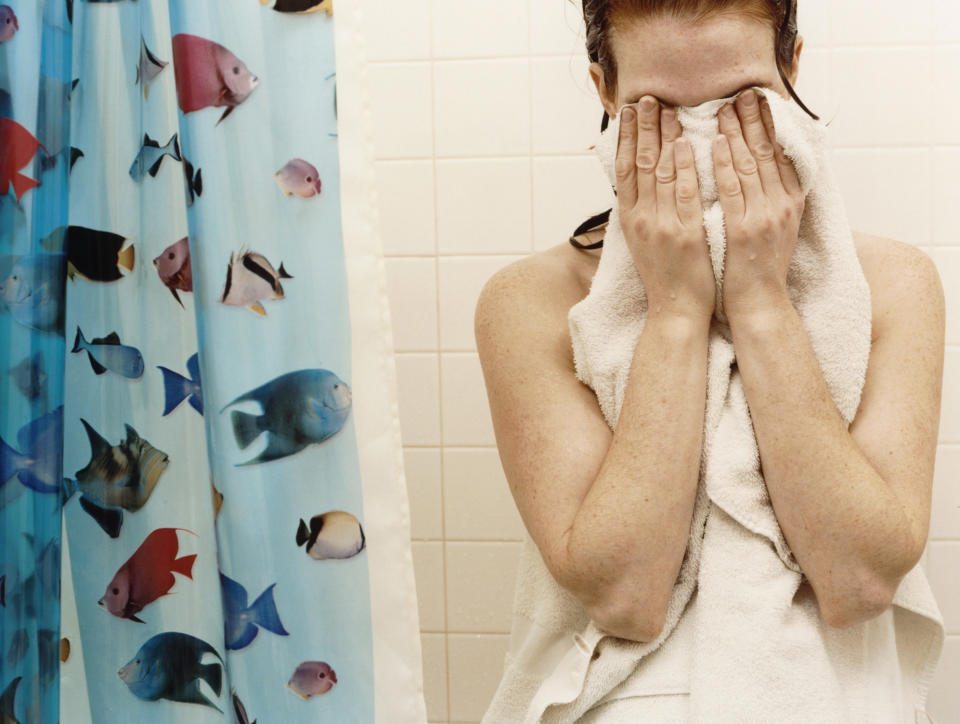 a person drying off in the shower