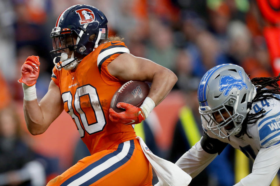 Denver Broncos running back Phillip Lindsay (30) breaks free from the grasp of Detroit Lions linebacker Jalen Reeves-Maybin (44) for a touchdown during the second half of an NFL football game, Sunday, Dec. 22, 2019, in Denver. (AP Photo/David Zalubowski)
