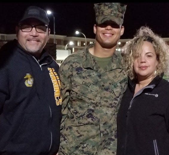Alec Cruz is pictured with his father, Albert, who was a gunnery sergeant, and mother Michelle, who was a police officer. Cruz, a Deltona High graduate, followed in their footsteps to become a military police officer in the Marines and recently won USO Marine of the Year.
