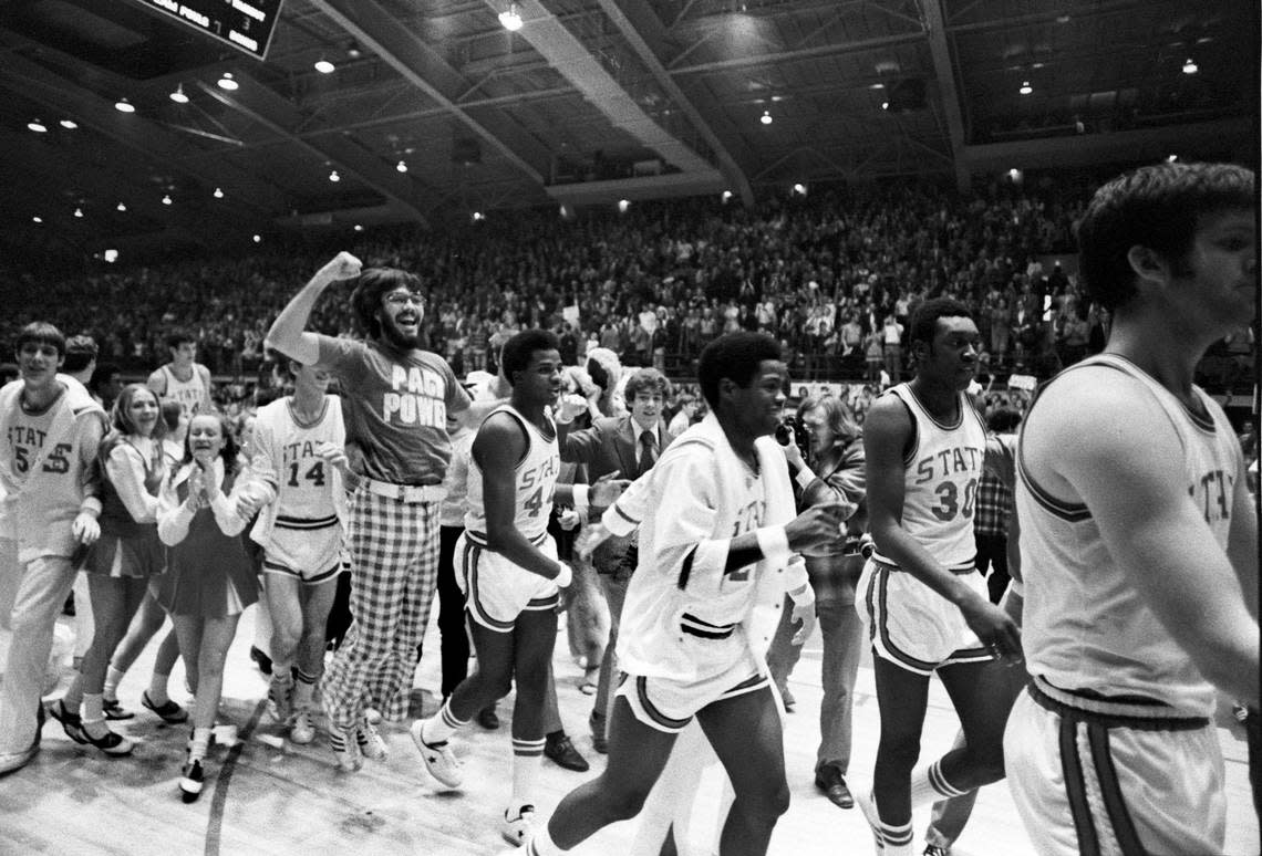 NC State fans, players and cheerleaders celebrate after the Wolfpack defeated Maryland in Reynolds Coliseum in 1974.