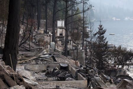 The remains of waterfront homes on Lake Chelan destroyed by the Chelan Complex fire are seen in Chelan, Washington August 24, 2015. REUTERS/David Ryder