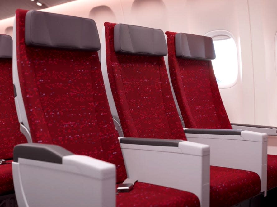 All-red economy seats with grey headrests.