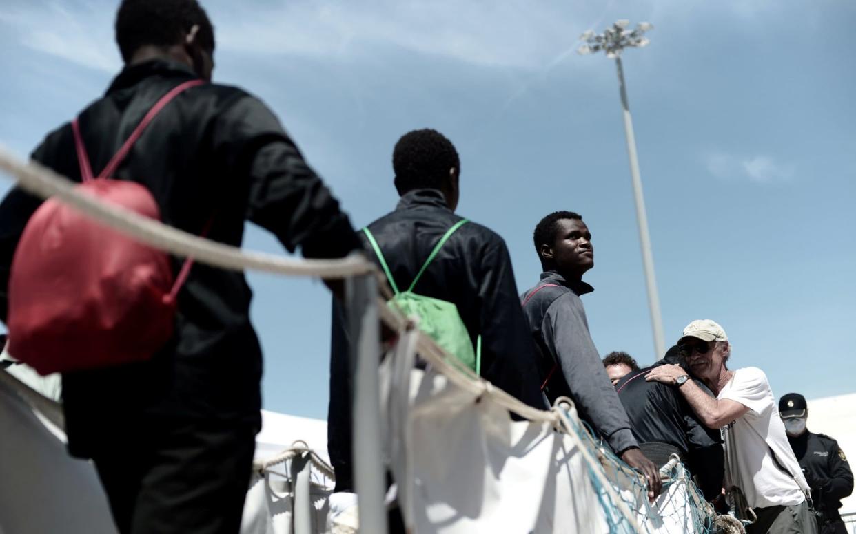 Migrants disembark from the Aquarius rescue ship, which finally docked in Spain after Italy closed its ports - REUTERS