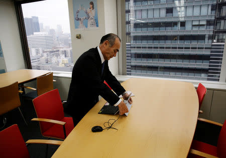 Yasuhiro Furuse, a senior adviser of corporate sales headquarters of Orix Corp., unfolds his laptop at a meeting room in Tokyo, Japan, February 19, 2019. REUTERS/Kim Kyung-hoon/Files