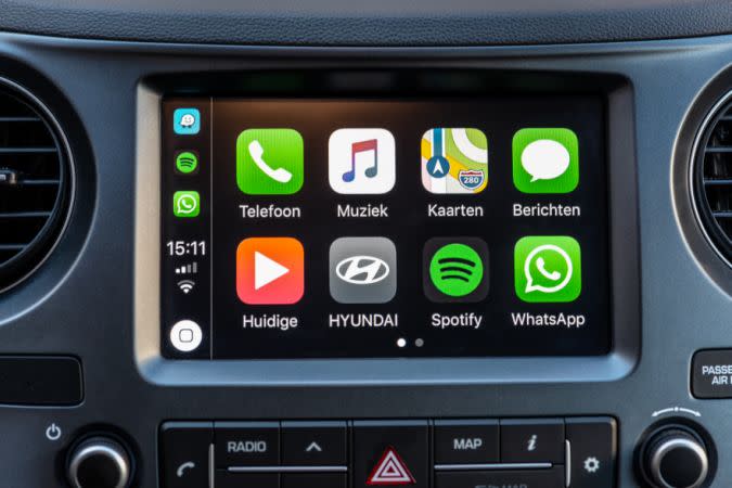 Alkmaar, The Netherlands - September 26, 2018: Apple CarPlay main screen in modern car dashboard. CarPlay is an Apple standard that enables a car radio or head unit to be a display and controller for an iPhone.