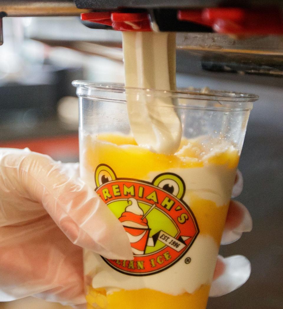 Cameron Cramer, a shift lead at Jeremiah&#39;s Italian Ice, makes a mango and vanilla gelati Tuesday, Jan. 4, 2022.