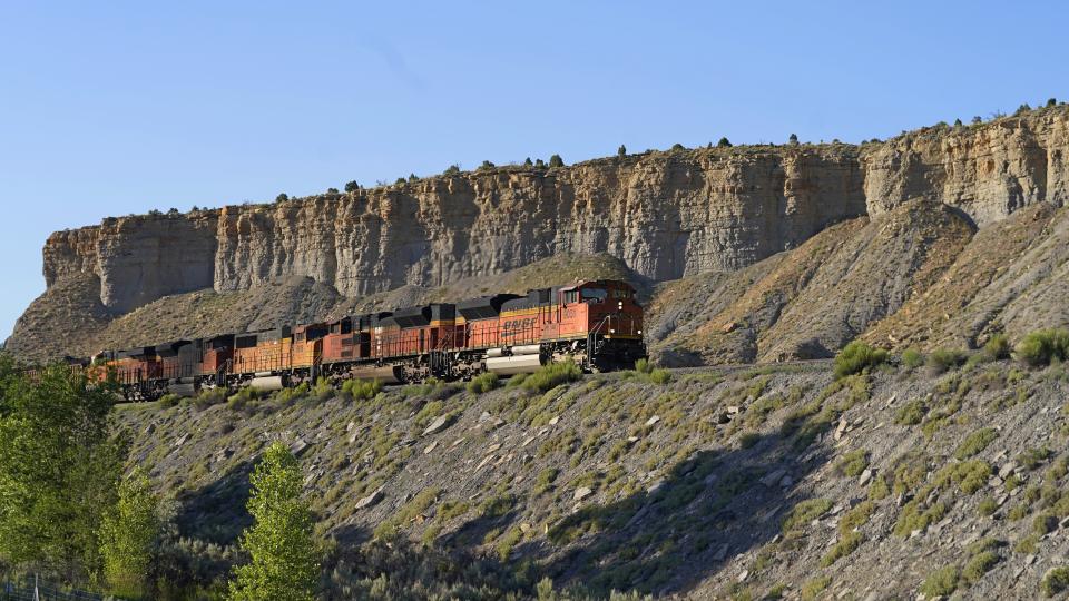 A train transports freight on a common carrier line near Price, Utah on Thursday, July 13, 2023. Uinta Basin Railway, which would connect to common carrier lines, could be an 88-mile line in Utah that would run through tribal lands and national forest to move oil and gas to the national rail network. Critics question investing billions in oil and gas infrastructure as the country seeks to use less of the fossil fuels that worsen climate change. (AP Photo/Rick Bowmer)