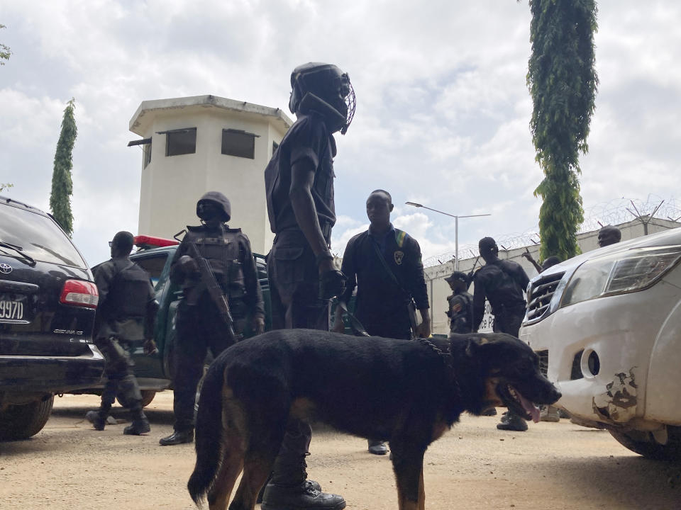 Officers stand guard outside the Kuje maximum prison following a rebel attack in Kuje, Nigeria, Wednesday, July 6, 2022. At least 600 inmates escaped in a jailbreak in Nigeria's capital city, officials said Wednesday, blaming the attack on Islamic extremist rebels. About 300 have been recaptured, authorities said. (AP Photo/Chinedu Asadu)