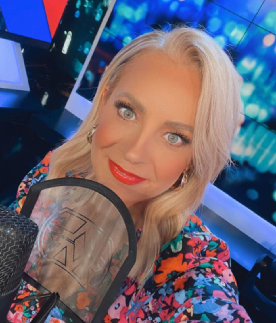 Selfie of Carrie Bickmore on The Project set, posing with a microphone
