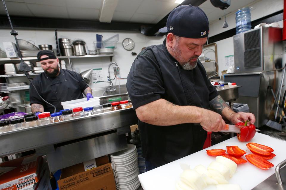 Head chef, Joe Rego, prepares vegetables for hamburgers at the newly opened New Beige Restaurant Bar & Market on Union Street in New Bedford.