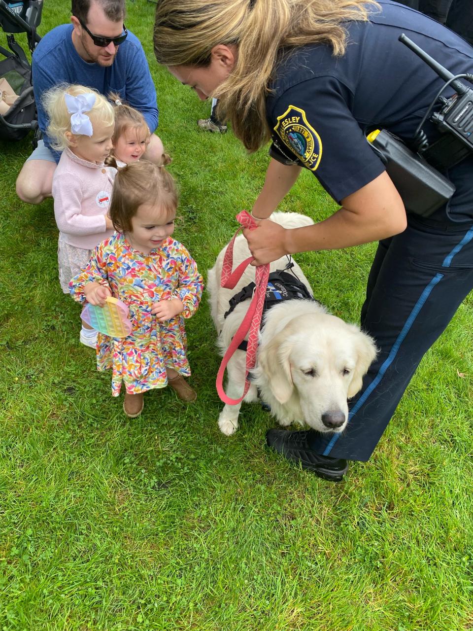 Children pet and greet "Winnie," Wellesley's K-9, during the Wellesley Mothers Forum's 2021 Fall Carnival.