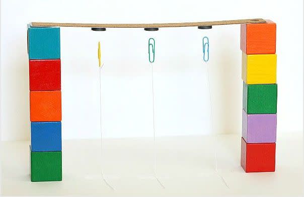 <p>Hang paperclips from a ruler or dowel, and they dangle, as they should, because of gravity. But you can show kids how other forces can overcome gravity by putting strong magnets on a ruler and using them to get the paperclips to stand straight up.</p><p><em><a href="https://buggyandbuddy.com/gravity/" rel="nofollow noopener" target="_blank" data-ylk="slk:Get the tutorial at Buggy and Buddy »" class="link ">Get the tutorial at Buggy and Buddy »</a></em></p>