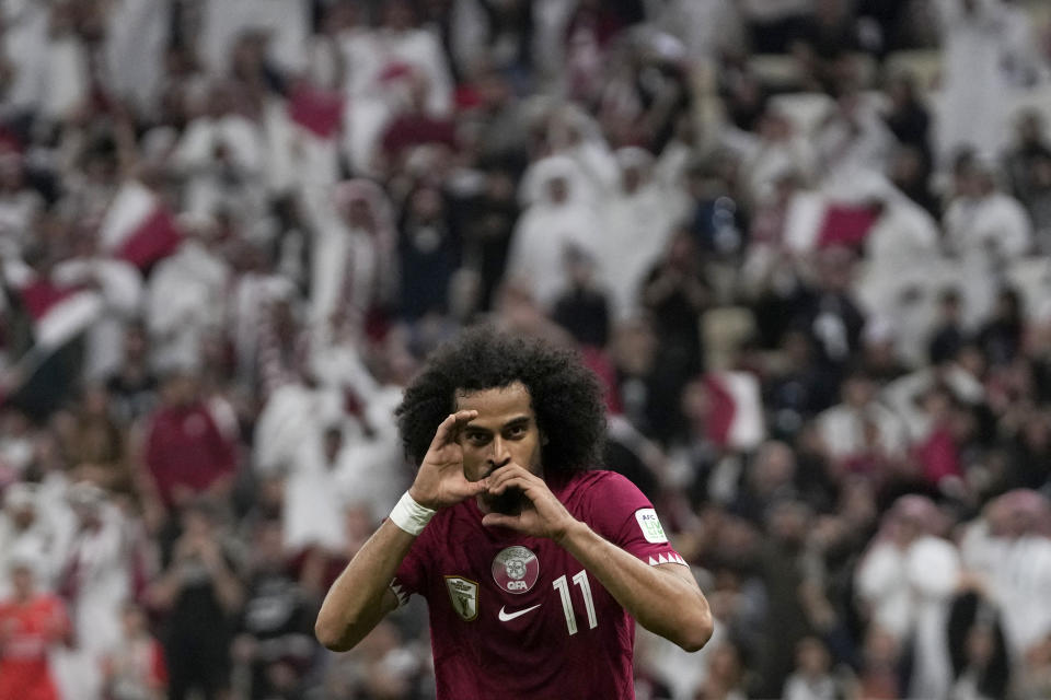 Qatar's Akram Afif celebrates after scoring the opening goal during the Asian Cup Group A soccer match between Qatar and Lebanon at the Lusail Stadium in Lusail, Qatar, Friday, Jan. 12, 2024. (AP Photo/Thanassis Stavrakis)