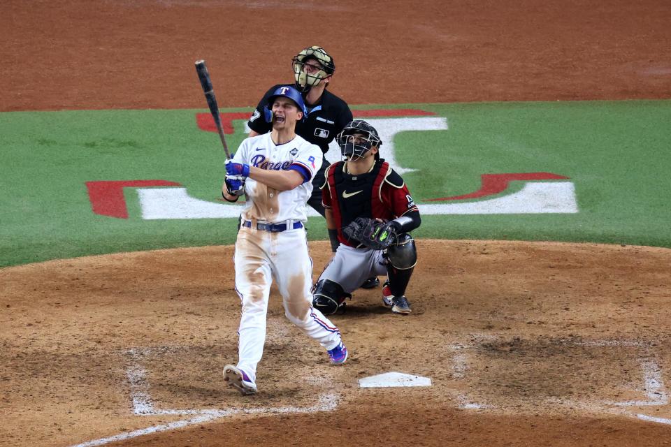 Rangers shortstop Corey Seager hits a two-run homer in the ninth inning against the Diamondbacks.