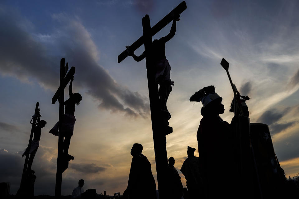 Penitents hang on crosses during a Way of the Cross reenactment, as part of Holy Week celebrations in the Petare neighborhood of Caracas, Venezuela, Friday, March 29, 2024. Holy Week commemorates the last week of the earthly life of Jesus Christ culminating in his crucifixion on Good Friday and his resurrection on Easter Sunday. (AP Photo/Matias Delacroix)