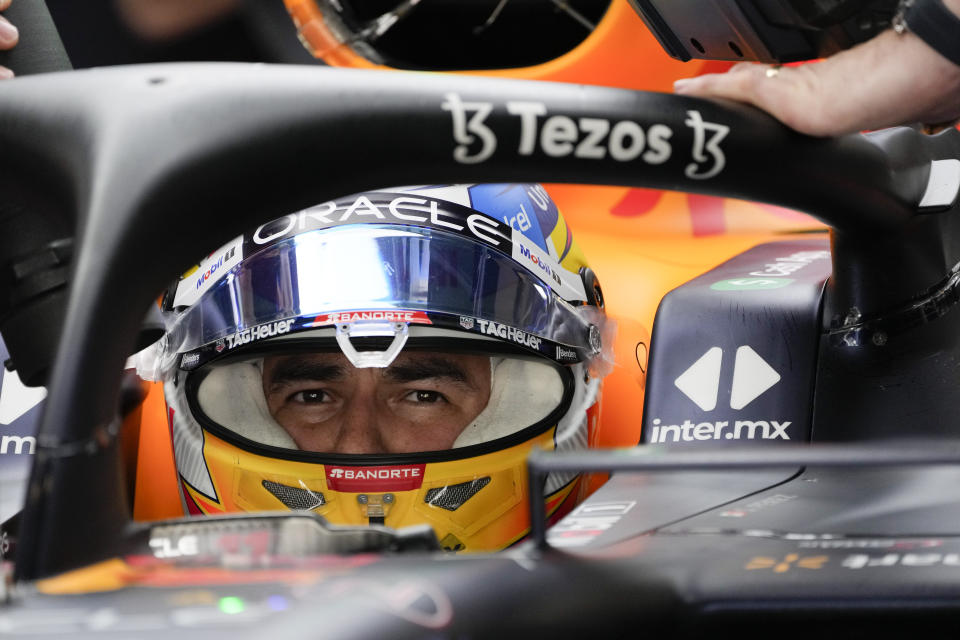 Red Bull driver Sergio Perez of Mexico sits in his car during practice for thethe Formula One Abu Dhabi Grand Prix, in Abu Dhabi, United Arab Emirates Friday, Nov. 18, 2022. (AP Photo/Hussein Malla)