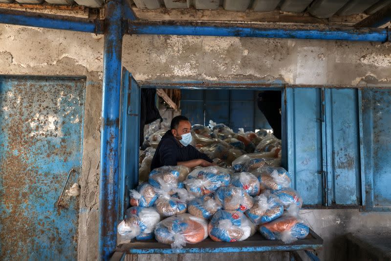 Palestinians receive food supplies at UNRWA distribution center in Gaza