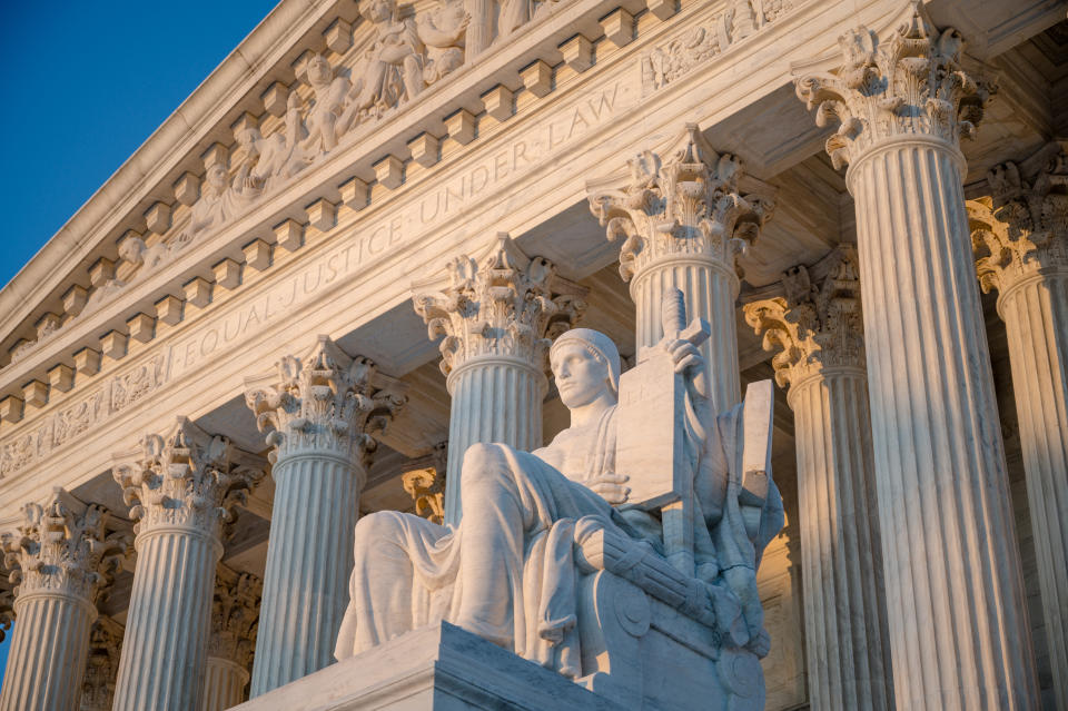 Exterior of Supreme Court of the United States on First Street in Washington DC, USA with statue by James Earle Fraser titled Authority of Law (1935)