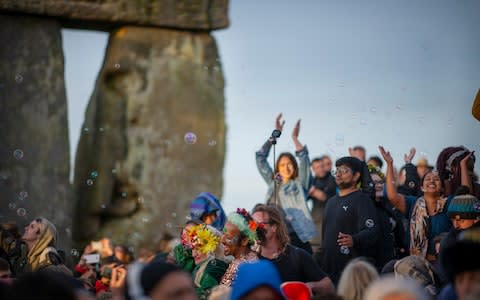 Revellers at the Summer Solstice Sunrise at Stonehenge, earlier today - Credit:  Geoff Pugh for the Telegraph