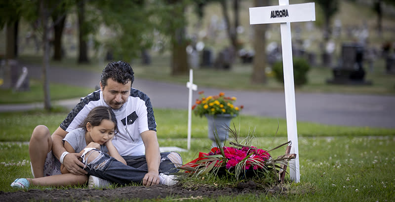 Juan Duran-Gutierrez and his daughter Aurora, 7, at the gravesite of his wife, and her mother, Aurora Chacon-Esparza, Thursday, August 6, who died from COVID-19 in July. (Elizabeth Flores / Star Tribune / Getty Images)