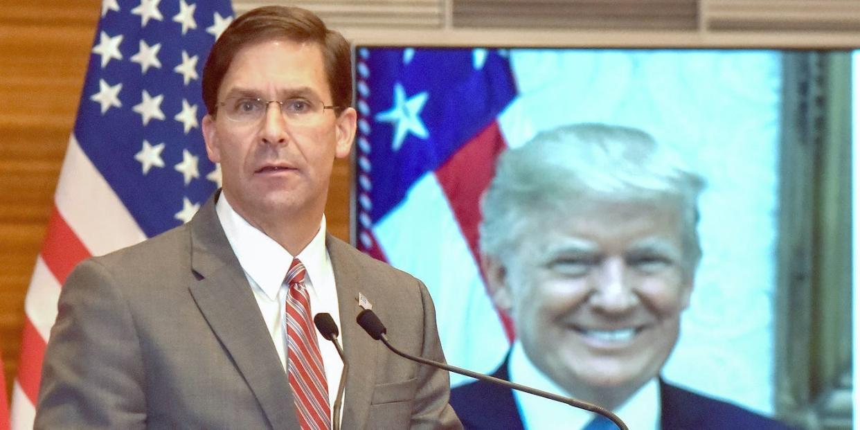 US Defence Secretary Mark Esper speaks in Morocco in front of a stock photo of Donald Trump.