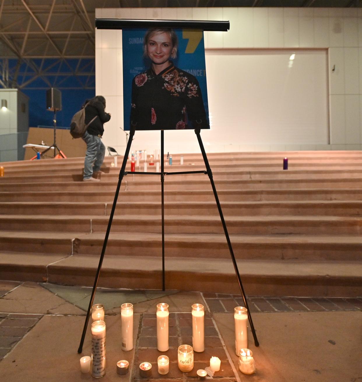 Candles are placed in front of a photo of cinematographer Halyna Hutchins during a vigil on Oct. 23, 2021, in Albuquerque, New Mexico.