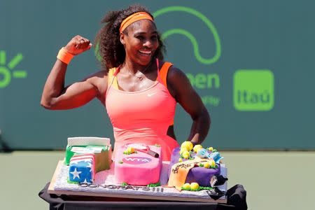 Serena Williams poses with a cake celebrating her 700th WTA win after her match against Sabine Lisicki (not pictured) on day ten of the Miami Open at Crandon Park Tennis Center. Williams won 7-6 (4), 1-6, 6-3. Mandatory Credit: Geoff Burke-USA TODAY