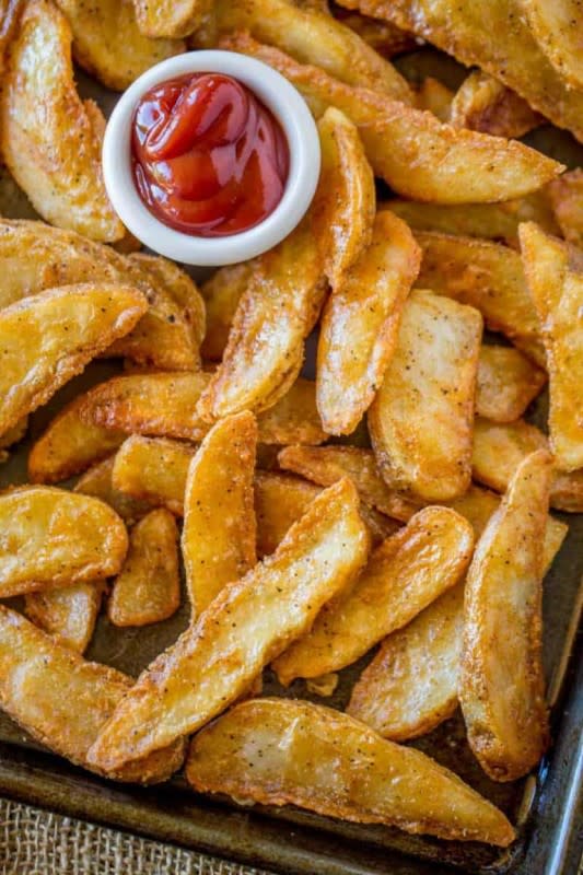 <p>Dinner Then Dessert</p><p>KFC Potato Wedges are lightly battered in a thin KFC chicken-flavored seasoning and double-fried until super crispy on the outside and fluffy on the inside.</p><p><strong>Get the recipe: </strong><a href="https://dinnerthendessert.com/kfc-potato-wedges/" rel="nofollow noopener" target="_blank" data-ylk="slk:KFC Potato Wedges;elm:context_link;itc:0;sec:content-canvas" class="link rapid-noclick-resp"><strong>KFC Potato Wedges</strong></a></p>