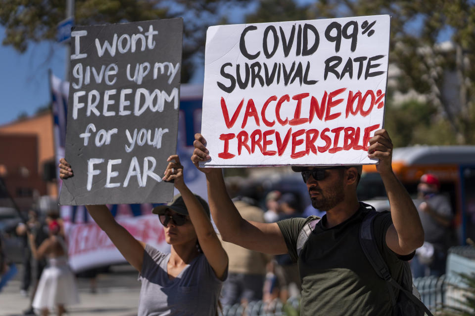 FILE - In this Sept. 18, 2021, file photo, protesters opposing COVID-19 vaccine mandates hold a rally in front of City Hall in downtown Los Angeles. COVID-19 deaths in the U.S. have climbed to an average of more than 1,900 a day for the first time since early March, with experts saying the virus is preying largely on a select group: 71 million unvaccinated Americans. (AP Photo/Damian Dovarganes, File)