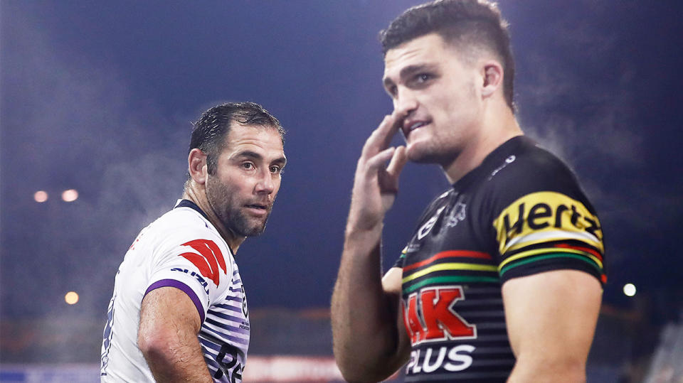 Cameron Smith (pictured left) looking back at Nathan Cleary (pictured right).