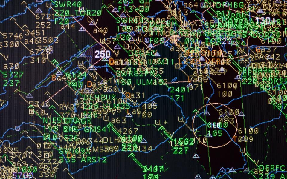 Computer monitors in the air traffic control show all the different flight paths of aircrafts in their air space