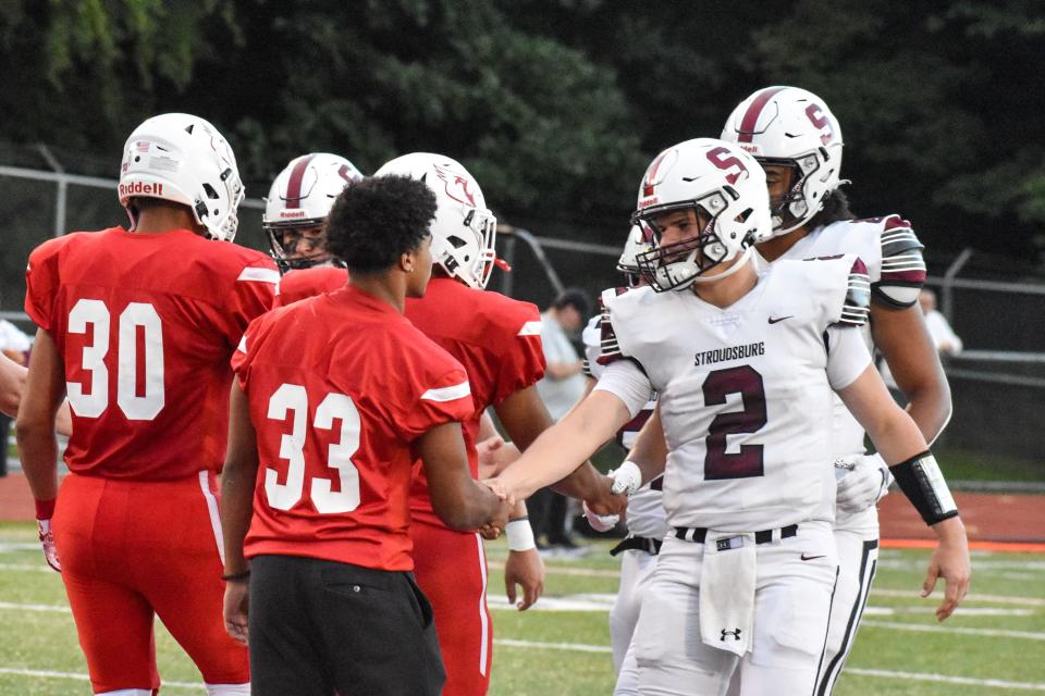 Stroudsburg and Pocono Mountain East players greet each other before their game on Friday, Sept. 3, 2021.