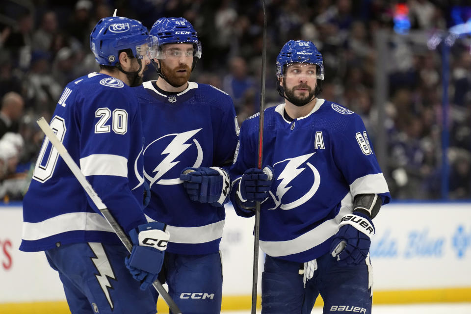 Tampa Bay Lightning right wing Nikita Kucherov (86) celebrates his goal against the St. Louis Blues with left wing Nicholas Paul (20) and defenseman Nick Perbix (48) during the second period of an NHL hockey game Tuesday, Dec. 19, 2023, in Tampa, Fla. (AP Photo/Chris O'Meara)