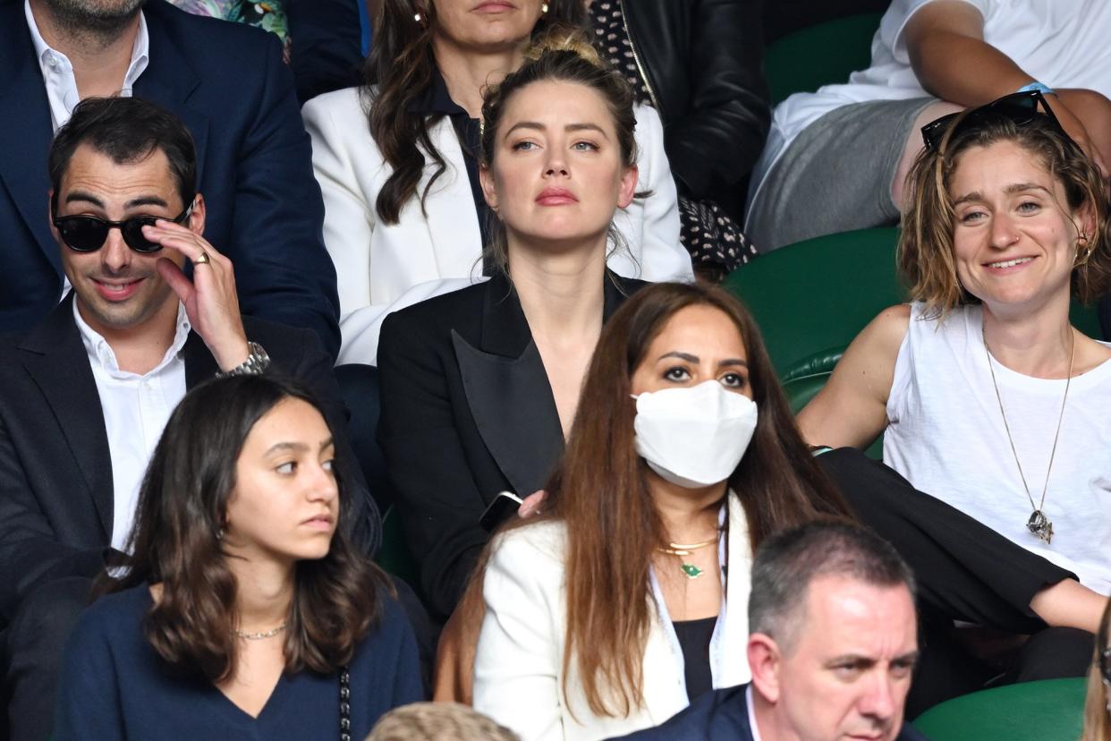 Amber Heard (C) attends day 13 of the Wimbledon Tennis Championships at All England Lawn Tennis and Croquet Club on July 11, 2021 in London