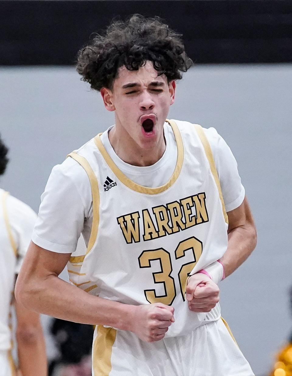 Warren Central's Robert Walker (32) yells in excitement scoring three points shorting the lead against Cathedral Fighting Irish on Friday, March 3, 2023 at Warren Central High School in Indianapolis. The Cathedral Fighting Irish defeated Warren Central, 64-61. 