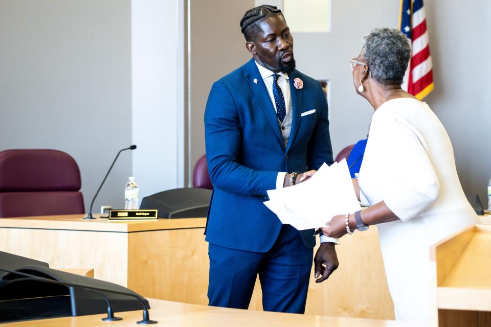 Ian Roberts shakes hands with Teree Caldwell-Johnson, board chair, after signing paperwork during a Des Moines Public Schools board meeting at Central Campus on Tuesday, May 16, 2023, in Des Moines.