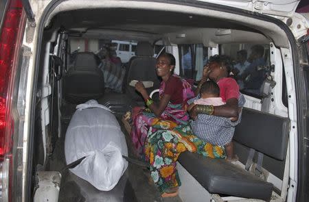 Unidentified women wail beside the body of a woman, who underwent sterilisation surgery at a government mass sterilisation camp, inside an ambulance outside Chhattisgarh Institute of Medical Sciences (CIMS) hospital in Bilaspur, Chhattisgarh, November 12, 2014. REUTERS/Stringer