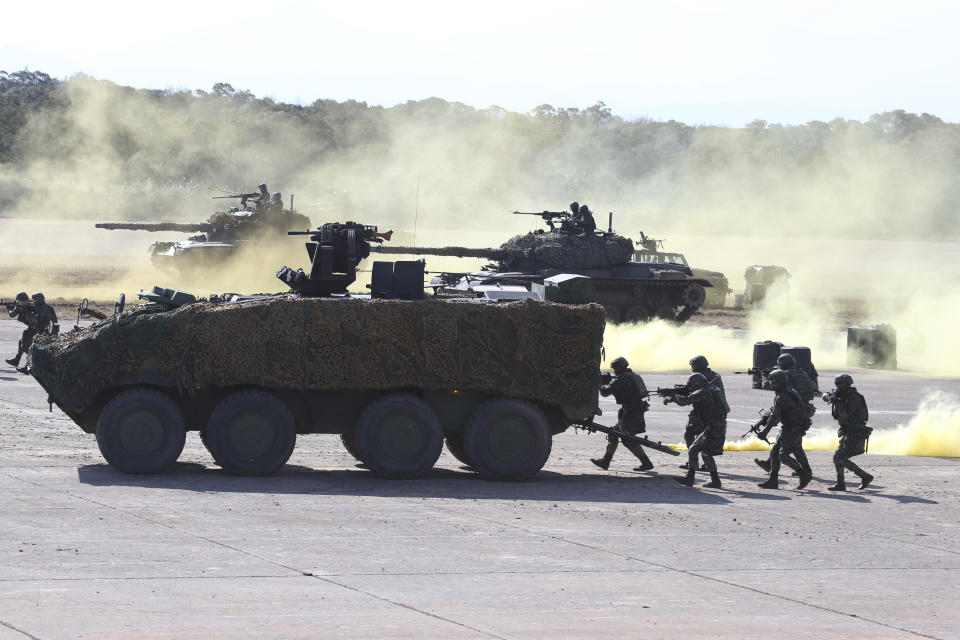 Soldiers take part in a military exercise in Hsinchu County, northern Taiwan, Tuesday, Jan. 19, 2021. Taiwanese troops using tanks, mortars and small arms staged a drill Tuesday aimed at repelling an attack from China, which has increased its threats to reclaim the island and its own displays of military might. (AP Photo/Chiang Ying-ying)