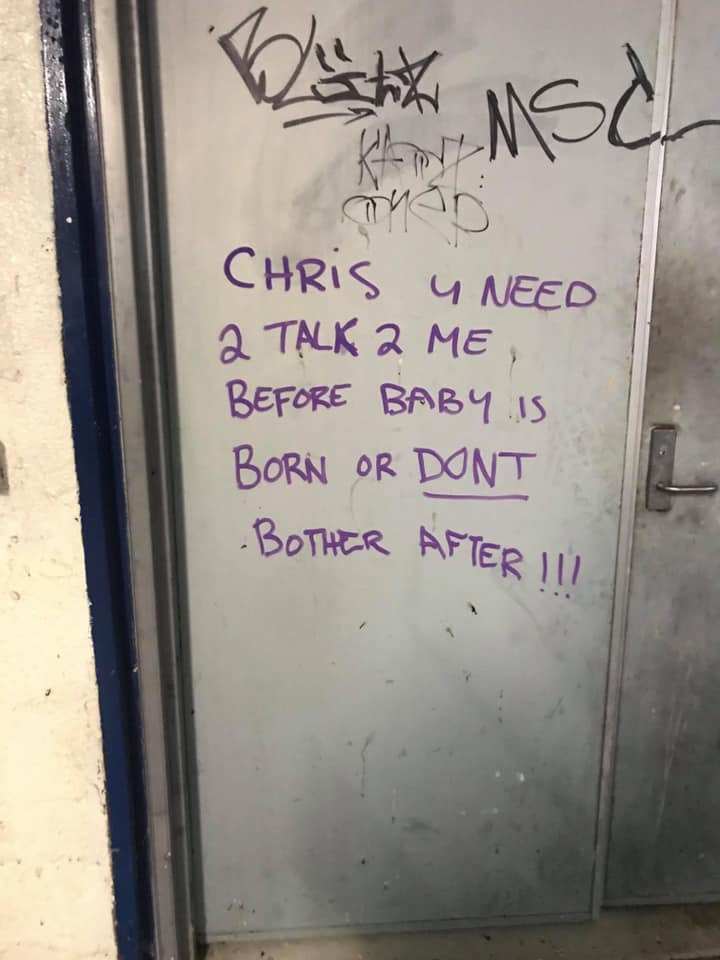 Purple graffiti on a metal door pleading for Chris to call her. 