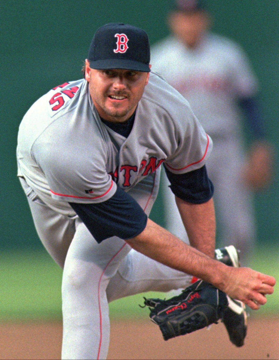 FILE - In this May 28, 1996, file photo, Boston Red Sox's Roger Clemens releases a pitch against the Oakland Athletics during a baseball game in Oakland, Calif., Coliseum. The Hall of Fame won’t have any new players in the class of 2021 after voters decided no one had the merits — on-the-field or off — for enshrinement in Cooperstown on this year's ballot. Curt Schilling, Barry Bonds and Clemens were the closest in voting by members of the Baseball Writers' Association of America released Tuesday, and the trio will have one more chance at election next year. It's the first time the BBWAA didn't choose anyone since 2013. (AP Photo/Ben Margot, File)