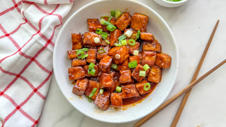 fiery tofu in bowl with chopsticks