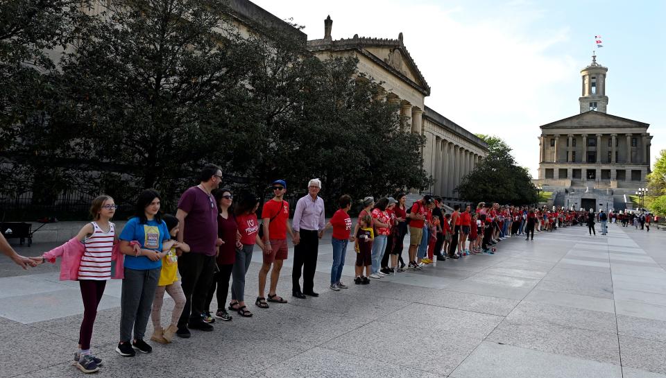 People lock arms and uses their First Amendment rights to demonstrate for gun control outside the state Capitol in April.