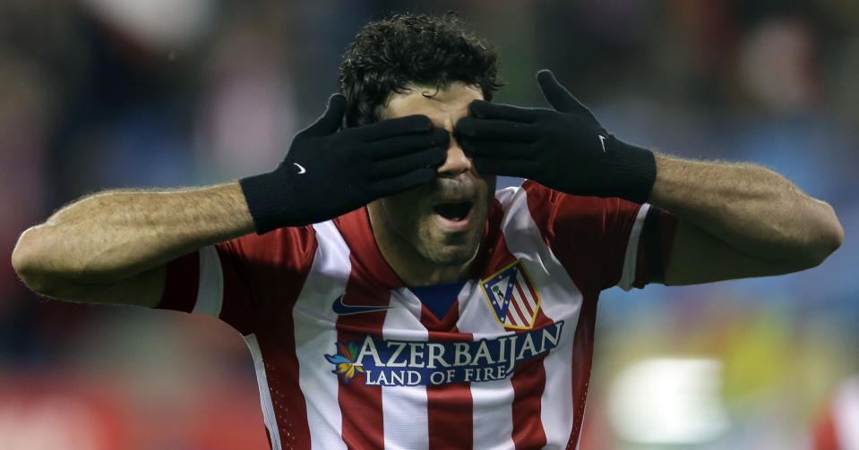 Atletico's Diego Costa celebrates scoring the opening goal during a Champions League, round of 16, second leg, soccer match between Atletico Madrid and AC Milan at the Vicente Calderon stadium in Madrid, Tuesday March 11, 2014. (AP Photo/Paul White)