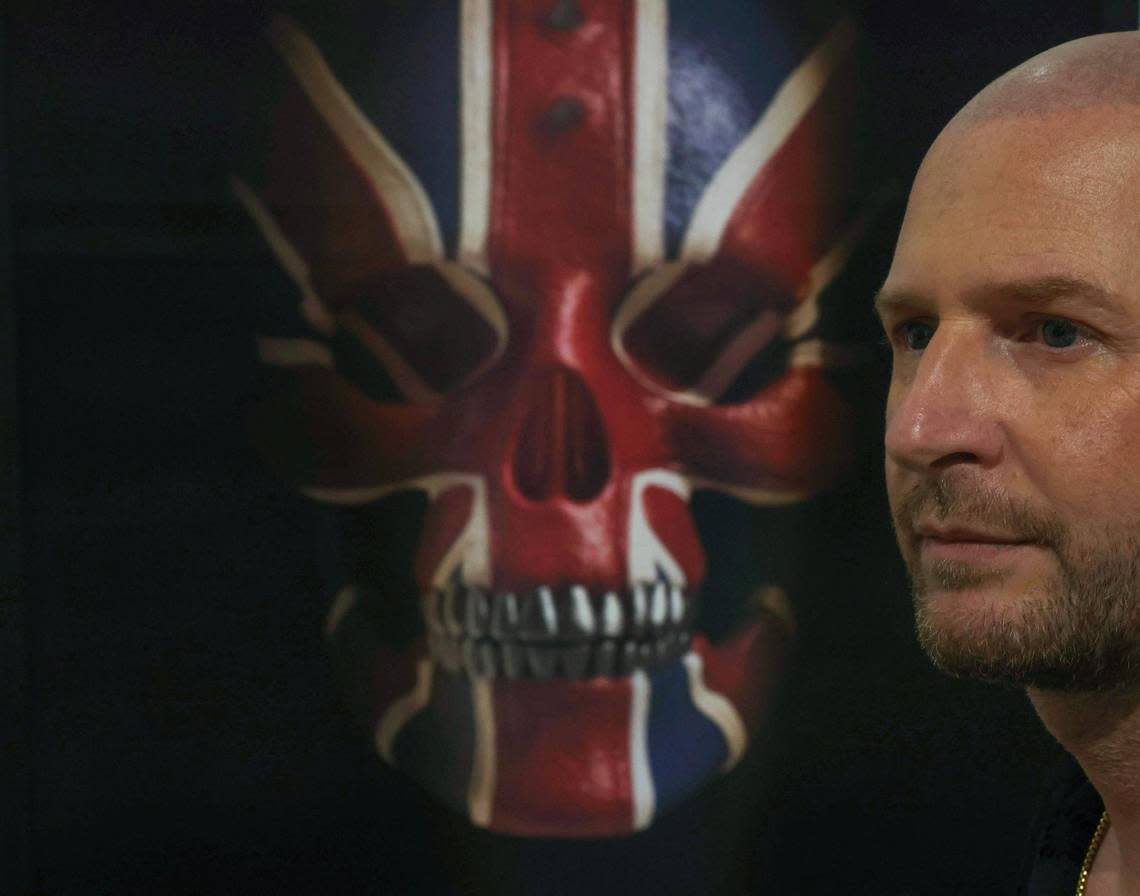 Artist Gary James McQueen is photographed alongside his work “Union Jack Skull” during Art Miami 2023 on Tuesday, Dec. 5, 2023, in downtown Miami, Fla.