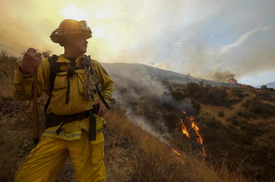 <p>A member with California Department of Forestry and Fire Protection (Cal Fire) battles a brushfire on the hillside in Burbank, Calif., Saturday, Sept. 2, 2017. (Photo: Ringo H.W. Chiu/AP) </p>