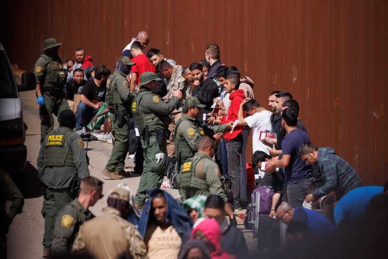 Migrants gather along the U.S. Mexico border near San Diego before the lifting of Title 42