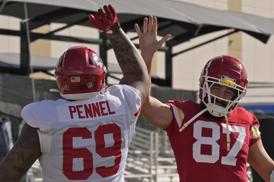 Kansas City Chiefs defensive tackle Mike Pennel Jr. (69) and Kansas City Chiefs tight end Travis Kelce (87) stretch during practice for Super Bowl 58 Thursday, Feb. 8, 2024 in Henderson, Nev. The Chiefs will play the NFL football game against the San Francisco 49ers Sunday in Las Vegas. (AP Photo/Charlie Riedel)