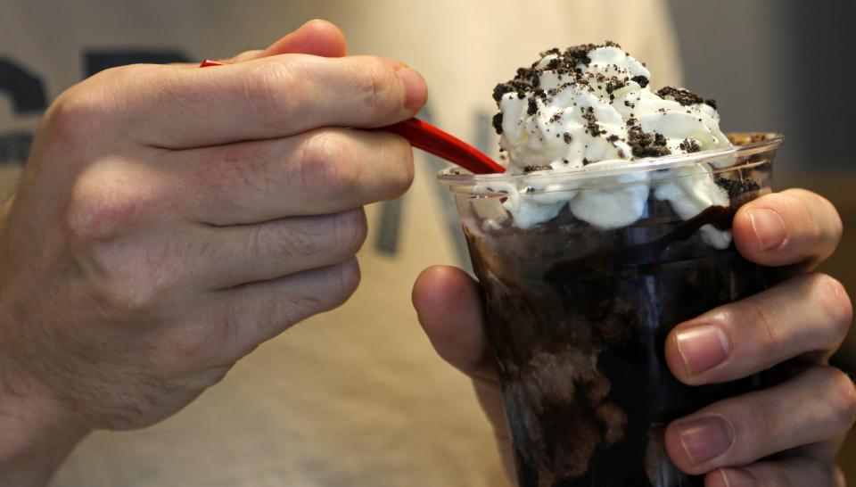 Caleb Everett eats a brownie sundae parfait at Boom Town Creamery in Oklahoma on Friday, July 7, 2023