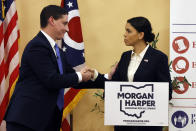 Josh Mandel, left, a Republican former Ohio treasurer, and Morgan Harper, a progressive Democrat running for an open U.S. Senate seat in Ohio, shake hands after a debate, Thursday, Jan. 27, 2022, in Columbus, Ohio. (AP Photo/Jay LaPrete)